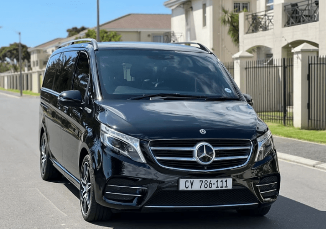 Black Mercedes-Benz V-Class van parked on a street with a clear view of its front and side.